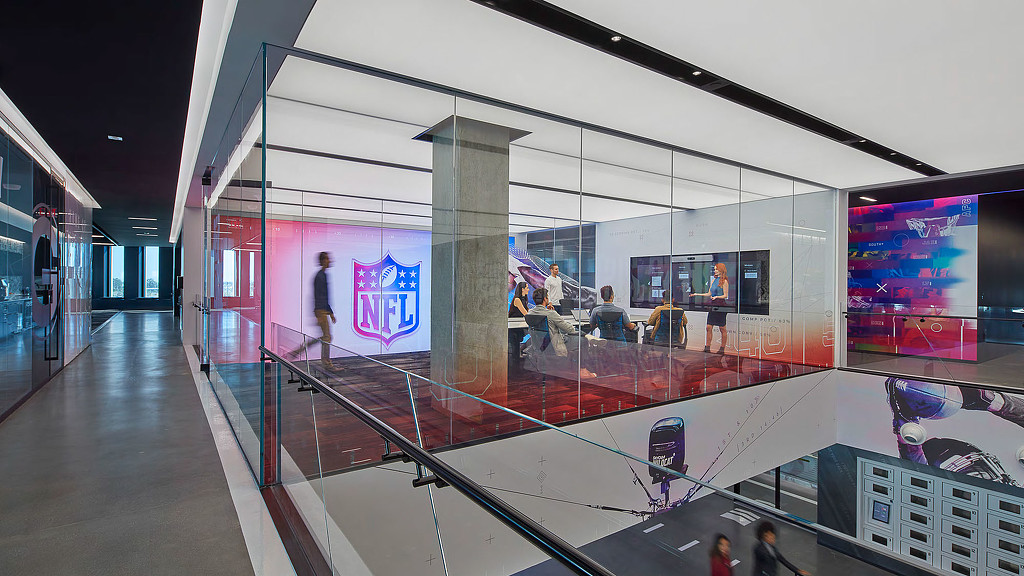 A group of people walking inside a building.